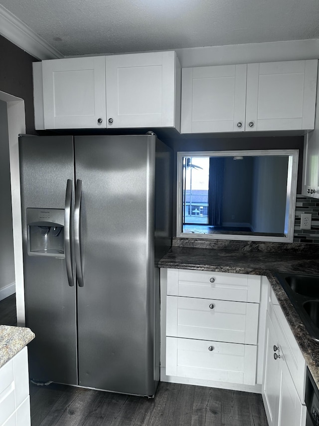 1040 SE 4th Ave Unit 222, Deerfield Beach, FL 33441 - kitchen with dark wood finished floors, stainless steel fridge, white cabinets, and dark stone countertops