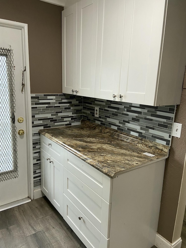 1040 SE 4th Ave Unit 222, Deerfield Beach, FL 33441 - kitchen featuring decorative backsplash, white cabinetry, dark stone countertops, and dark wood-style floors