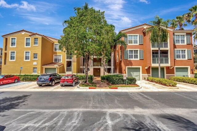11760 Saint Andrews Pl Unit 204, Wellington, FL 33414 - view of property with a garage