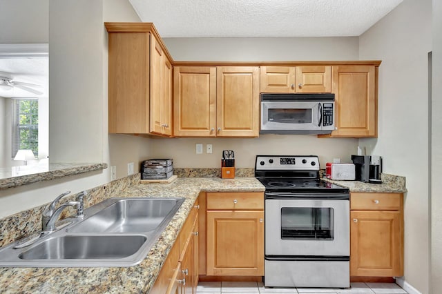 11760 Saint Andrews Pl Unit 204, Wellington, FL 33414 - kitchen featuring light tile patterned floors, a ceiling fan, a sink, and appliances with stainless steel finishes