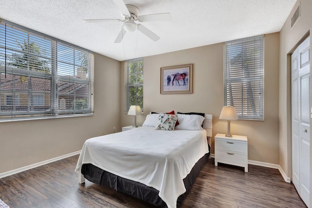 11760 Saint Andrews Pl Unit 204, Wellington, FL 33414 - bedroom with a textured ceiling, visible vents, baseboards, a ceiling fan, and wood finished floors