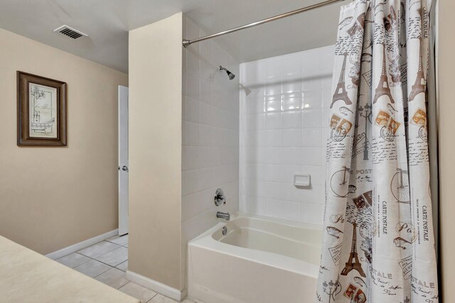 11760 Saint Andrews Pl Unit 204, Wellington, FL 33414 - bathroom featuring shower / bath combo, visible vents, tile patterned flooring, and baseboards