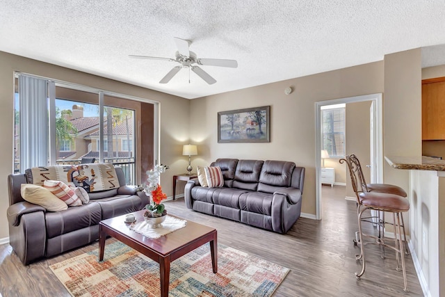 11760 Saint Andrews Pl Unit 204, Wellington, FL 33414 - living area with a textured ceiling, light wood-style floors, and ceiling fan