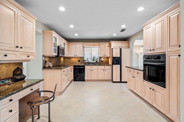 kitchen featuring backsplash, black appliances, recessed lighting, and visible vents