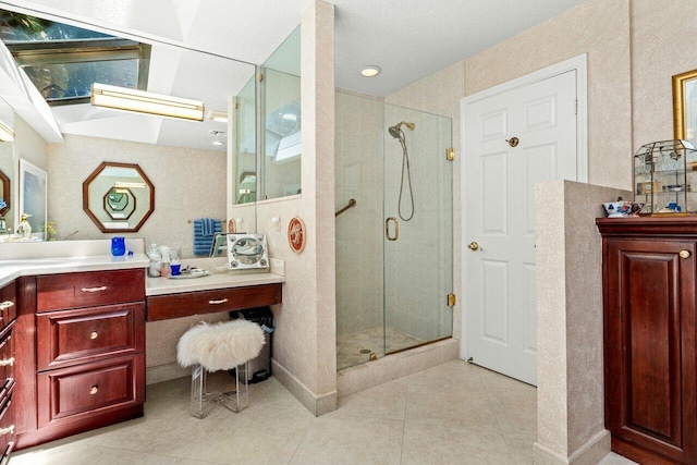 bathroom featuring vanity, tile patterned flooring, and a shower stall