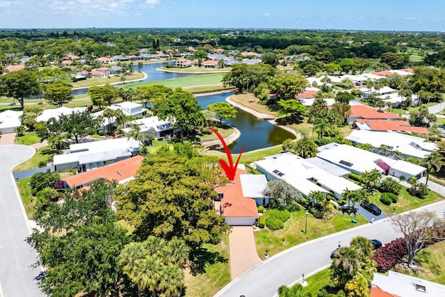 drone / aerial view with a water view and a residential view