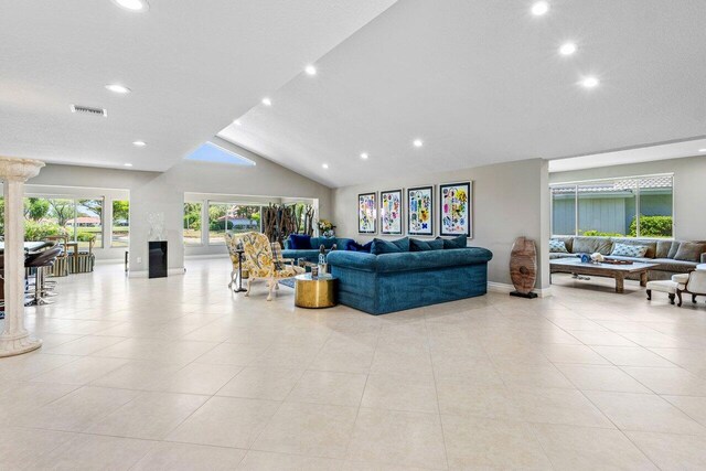living room featuring visible vents, light tile patterned floors, baseboards, lofted ceiling, and recessed lighting