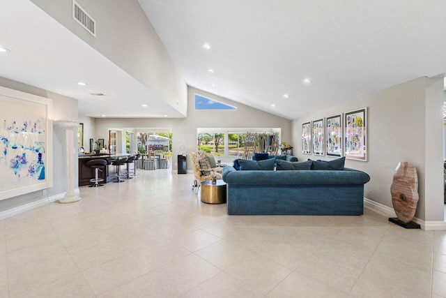 living room with visible vents, baseboards, tile patterned floors, high vaulted ceiling, and recessed lighting