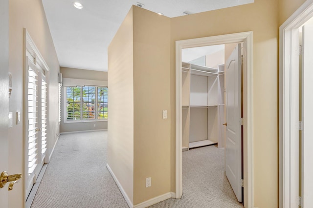 hall with baseboards and carpet