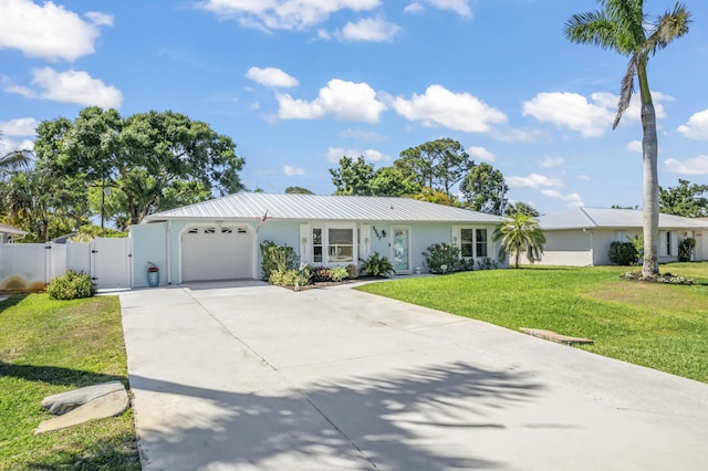 single story home featuring a gate, driveway, a garage, a front yard, and stucco siding