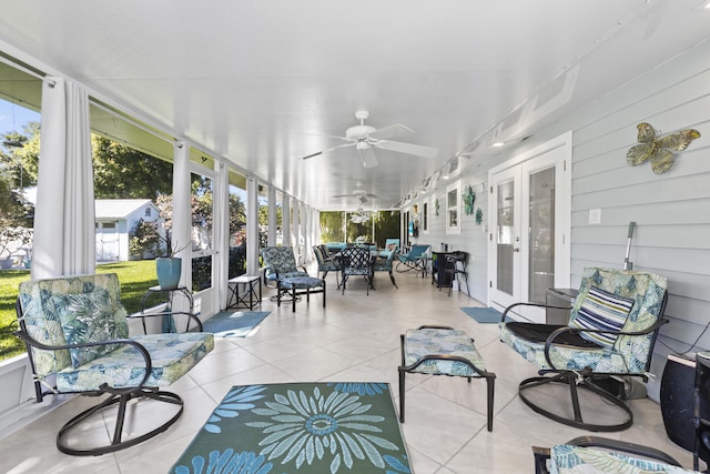 sunroom / solarium featuring outdoor dining space, a wealth of natural light, and ceiling fan