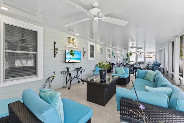 sunroom featuring an outdoor living space, a ceiling fan, and outdoor dining area