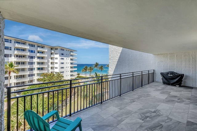 balcony featuring area for grilling and a water view