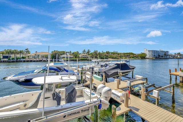 dock area with boat lift and a water view