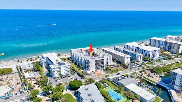 drone / aerial view featuring a view of the beach and a water view