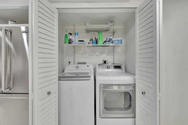washroom featuring washing machine and dryer and laundry area