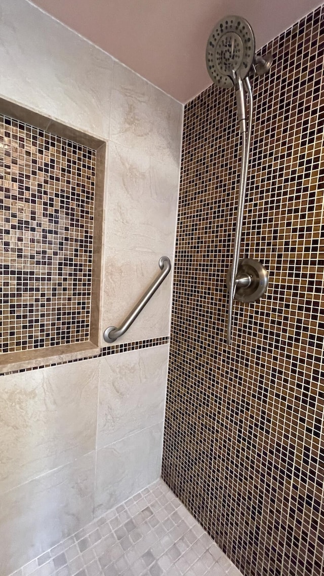 full bath with a tile shower