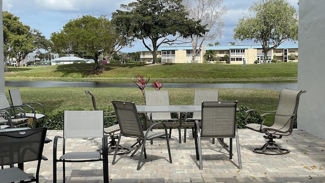 view of patio / terrace with outdoor dining area and a water view