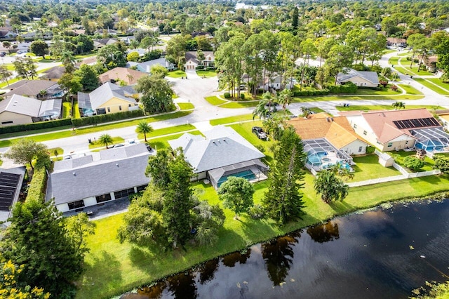 drone / aerial view featuring a water view and a residential view