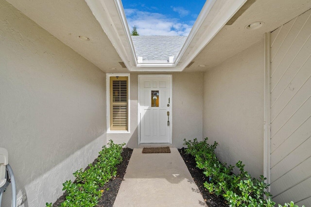 doorway to property featuring stucco siding