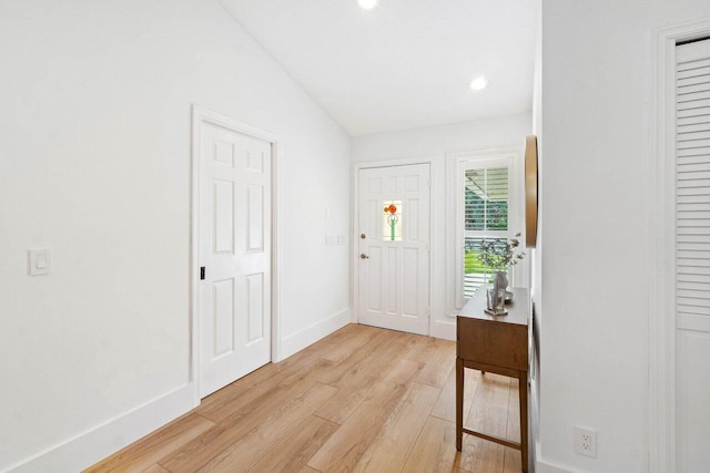 entryway with light wood finished floors, baseboards, and recessed lighting