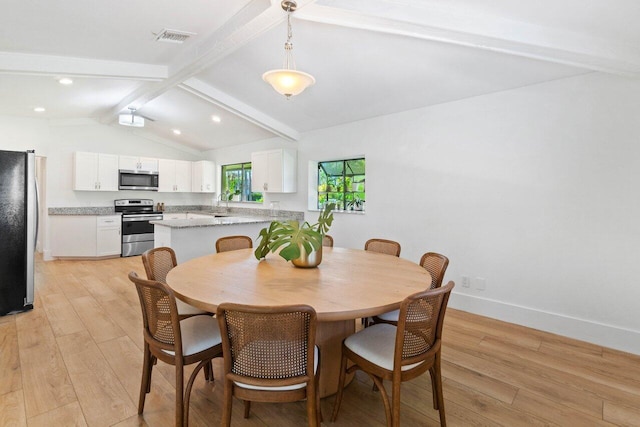 dining room featuring light wood-style flooring, visible vents, vaulted ceiling with beams, and baseboards