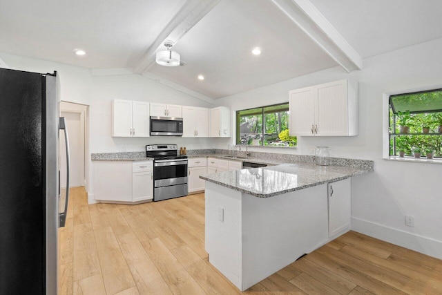 kitchen featuring white cabinets, baseboards, a peninsula, light wood-style flooring, and appliances with stainless steel finishes