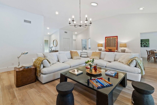 living area with recessed lighting, an inviting chandelier, vaulted ceiling, visible vents, and light wood-style flooring
