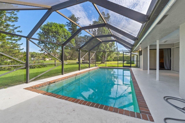pool with glass enclosure, a yard, and a patio