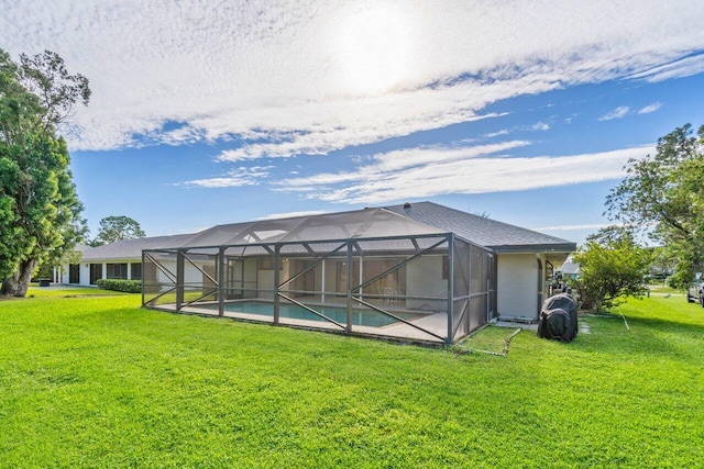 rear view of house featuring a lawn, an outdoor pool, and glass enclosure