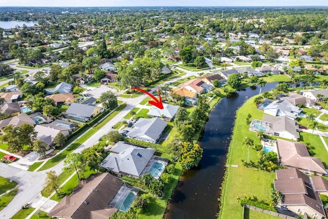birds eye view of property with a residential view and a water view