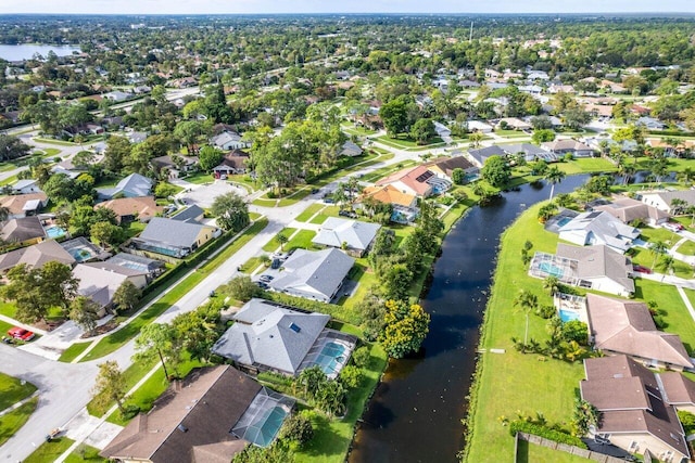 bird's eye view featuring a water view and a residential view