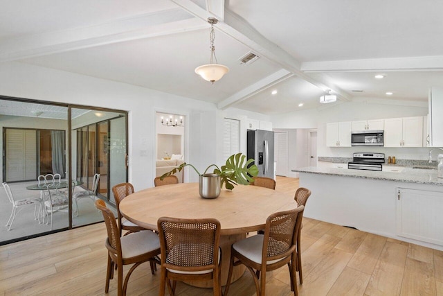 dining space with vaulted ceiling with beams, visible vents, an inviting chandelier, and light wood-style floors
