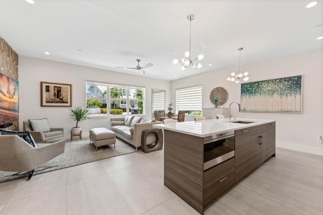 kitchen featuring modern cabinets, open floor plan, a sink, and light countertops