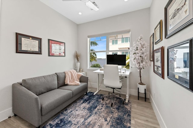 office space featuring recessed lighting, light wood-type flooring, a ceiling fan, and baseboards