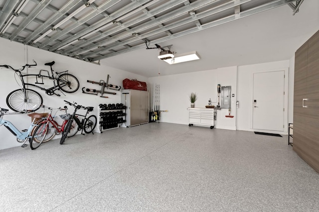 garage featuring electric panel and a garage door opener