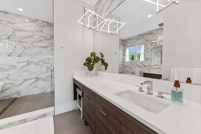 full bath with a marble finish shower, baseboards, recessed lighting, marble finish floor, and vanity