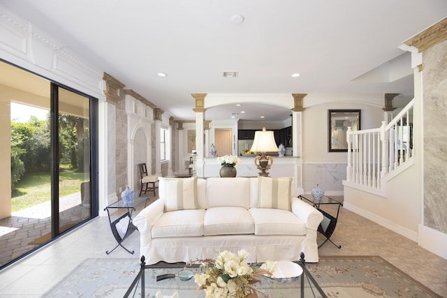 tiled living room featuring decorative columns, stairway, and recessed lighting