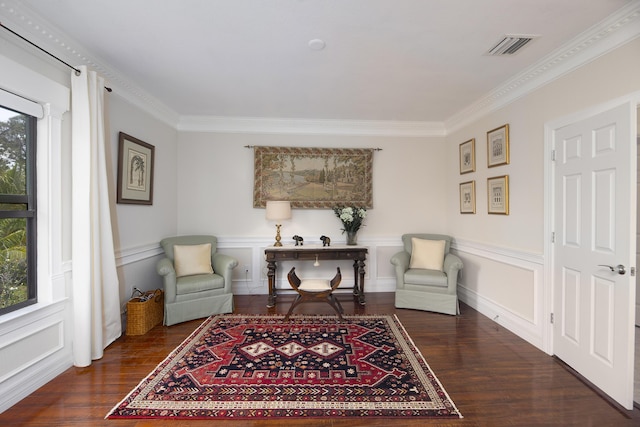 living area with wood finished floors and crown molding