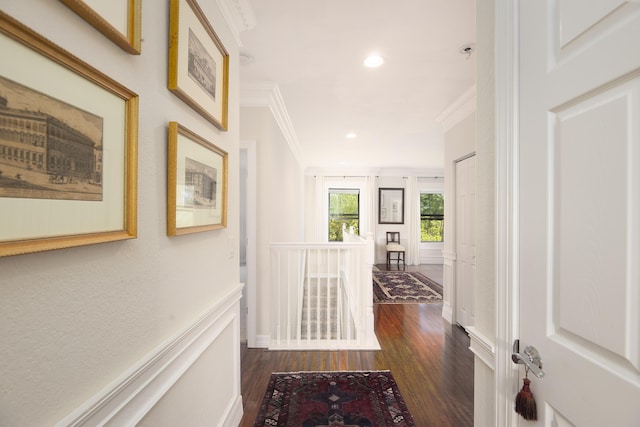 hallway with ornamental molding, dark wood finished floors, recessed lighting, and baseboards