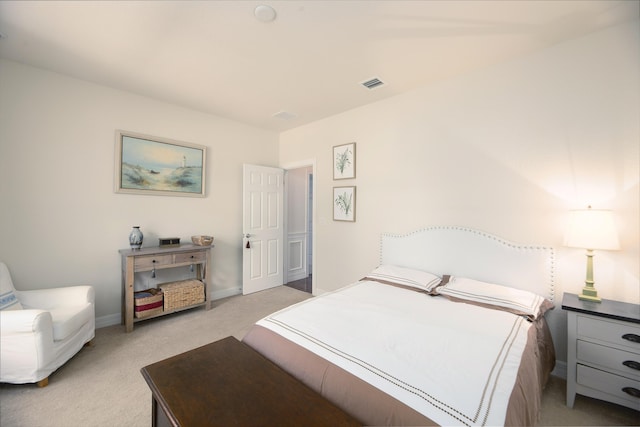 bedroom featuring light colored carpet and baseboards