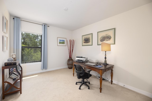 carpeted office featuring baseboards