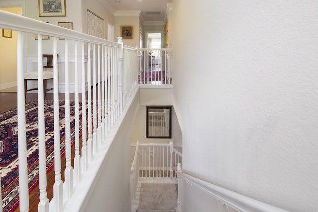 staircase featuring crown molding