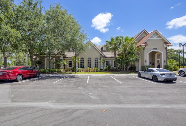view of property featuring uncovered parking