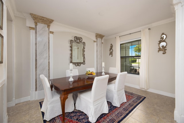 dining area featuring decorative columns, baseboards, and light tile patterned flooring