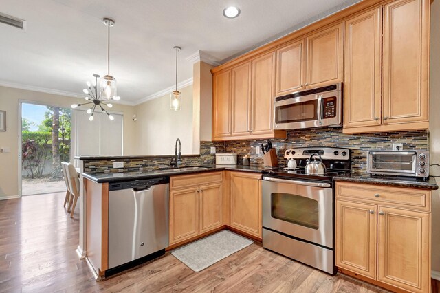 4721 N Prive Cir, Delray Beach, FL 33445 - kitchen with visible vents, a toaster, a sink, light wood finished floors, and stainless steel appliances