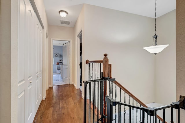 4721 N Prive Cir, Delray Beach, FL 33445 - hall with baseboards, an upstairs landing, wood finished floors, and visible vents