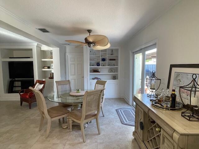 1028 SE 13th Ct, Deerfield Beach, FL 33441 - dining area with ceiling fan, a textured ceiling, built in features, visible vents, and ornamental molding