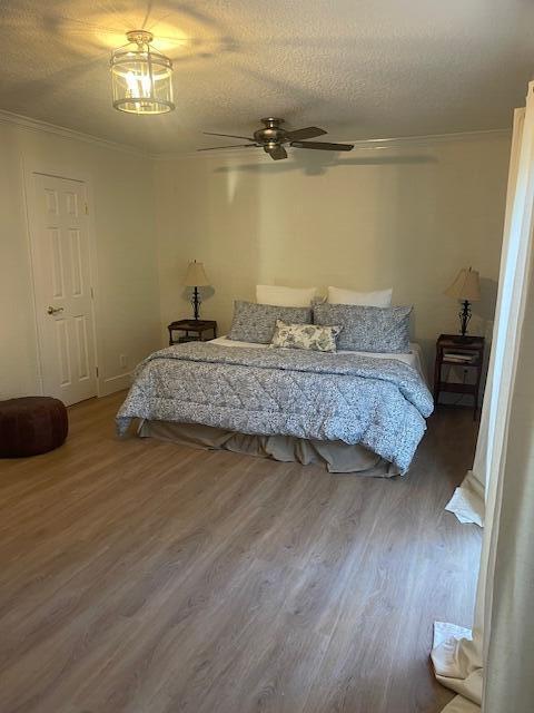 1028 SE 13th Ct, Deerfield Beach, FL 33441 - bedroom featuring crown molding, a ceiling fan, a textured ceiling, and wood finished floors