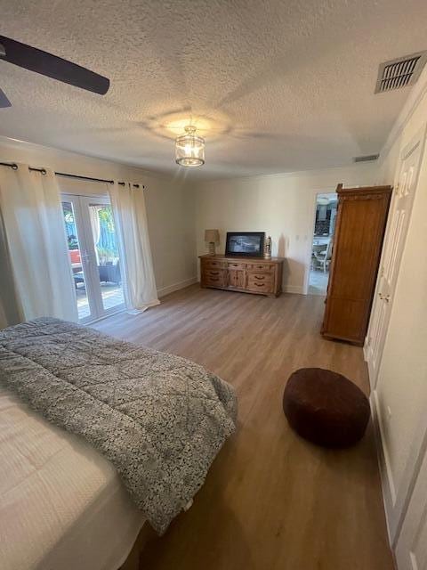 1028 SE 13th Ct, Deerfield Beach, FL 33441 - bedroom featuring baseboards, visible vents, access to exterior, and light wood-style flooring
